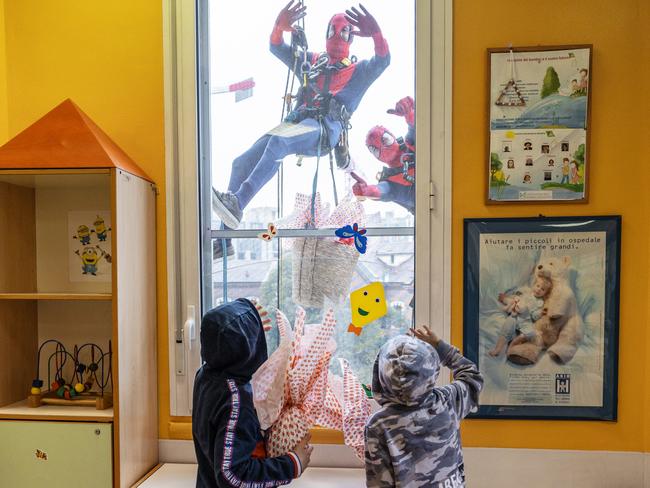 Workers dressed as Spider-Man greet hospitalised children in Milan, Italy. Picture: Emanuele Cremaschi/Getty Images