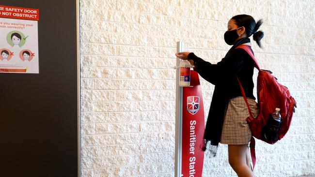 Student at Caroline Chisholm Catholic College in Braybrook in Melbourne's west sanitise their hands as they return to school. Picture: Andrew Henshaw