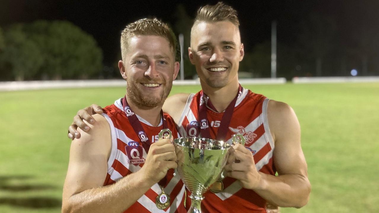 Yeppoon Swans' Jayden Pain and player/coach Christian Burgess with the premiership trophy.