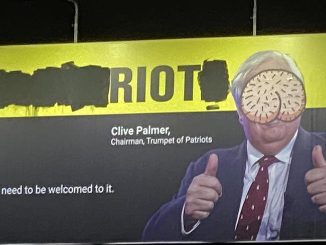 Clive Palmer's campaign board above a Brunswick petrol station has been vandalised with graffiti. Picture: Supplied.