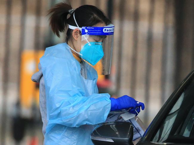 SYDNEY, AUSTRALIA - NewsWire Photos JULY 26, 2021 - Health workers testing people at the Fairfield Showground Covid testing site.Picture: NCA NewsWire / Christian Gilles