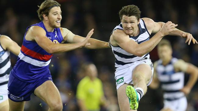 Patrick Dangerfield gets a kick away in front of Marcus Bontempelli. Picture: Michael Klein