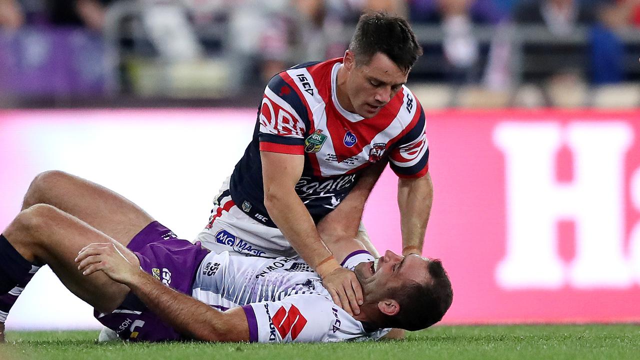 Cooper Cronk and Cameron Smith clash in the first half.