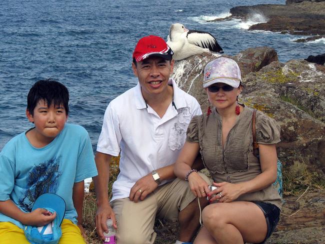 Henry Lin, 12, (left) with his parents Min and Lily Lin before their brutal murders in the family home in 2009.