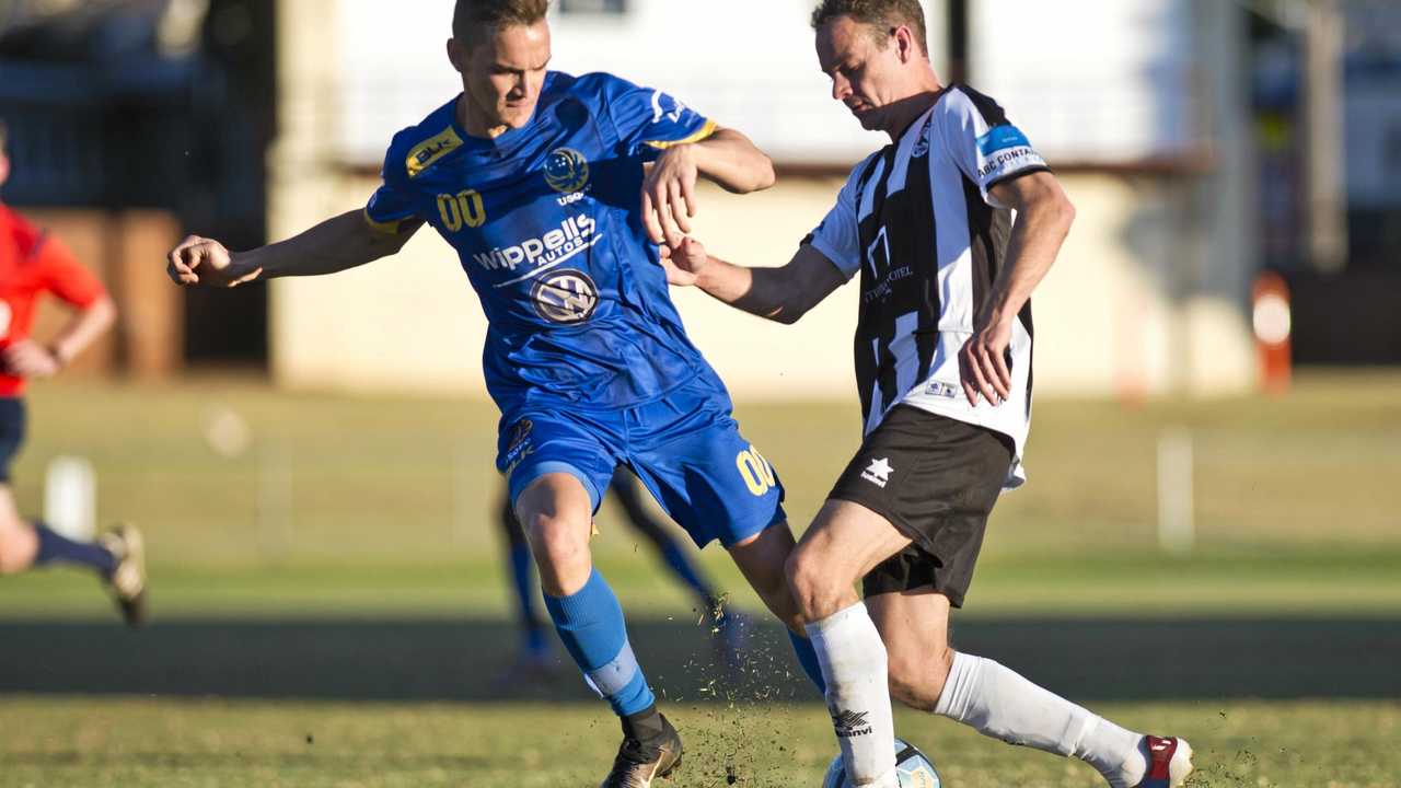 IN ACTION: USQ's Daniel Fuller (left) attempts to tackle Willowburn's Peter Millican in last year's Toowoomba Football League grand final. The team's will face each other in the opening round of this year's competition. Picture: Nev Madsen