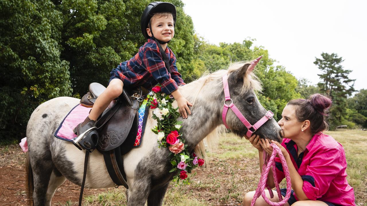 Pony Parties Toowoomba owner Lauren Sykes takes her son Josiah Sykes for a pony ride on Cookie. Picture: Kevin Farmer