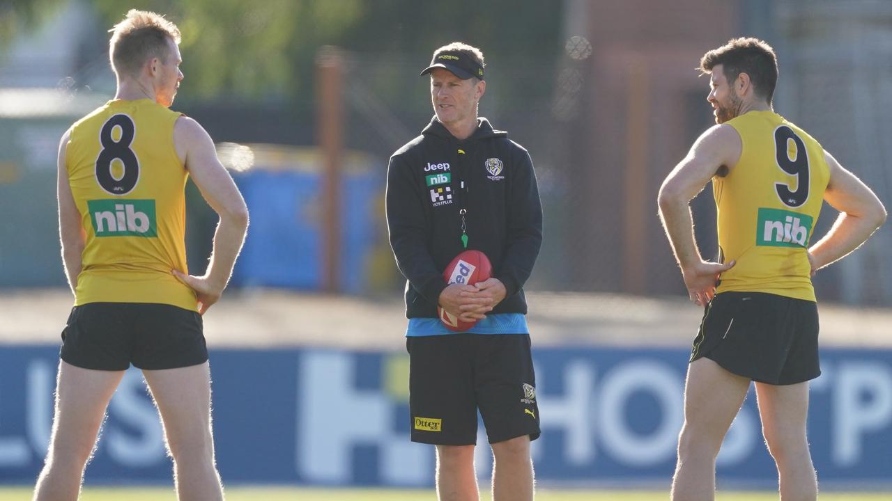 Damien Hardwick, coach of the Tigers, talks to veterans Trent Cotchin and Jack Riewoldt.