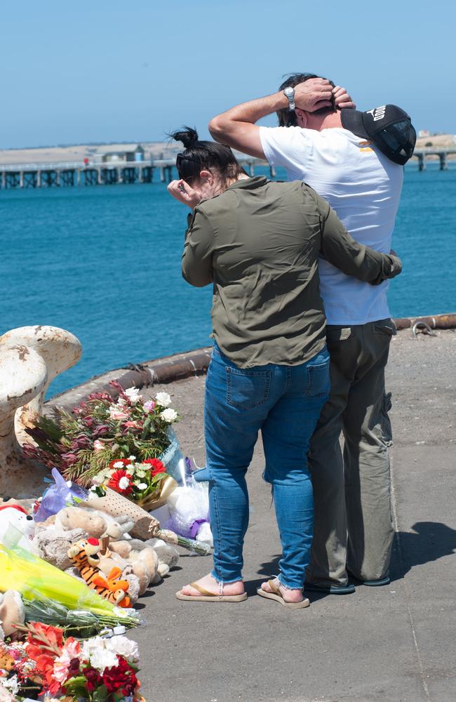 A visibly distressed Shannon Little is supported at the scene. Photo: Ivon Perrin