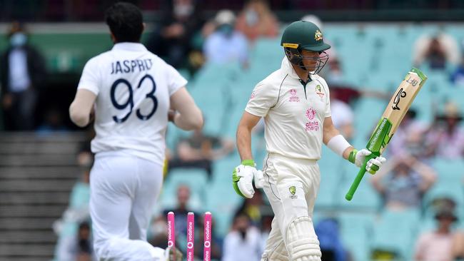 Australian captain Tim Paine (R) is clean bowled by Indian paceman Jasprit Bumrah (L) on day two of the third cricket Test match at Sydney Cricket Ground (SCG) between Australia and India on January 8, 2021. (Photo by Saeed KHAN / AFP) / --IMAGE RESTRICTED TO EDITORIAL USE - NO COMMERCIAL USE--