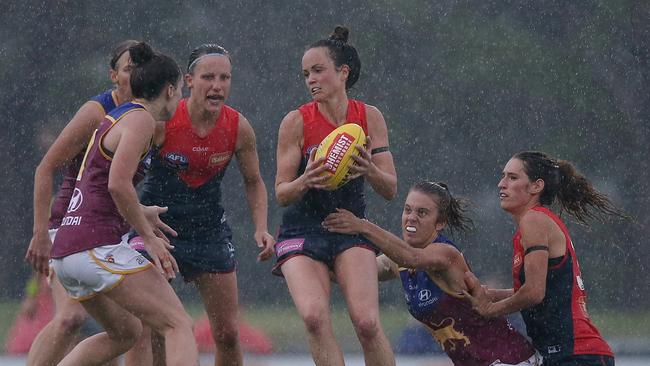 Melbourne star Daisy Pearce tries to break through traffic in the wet conditions. Picture: Wayne Ludbey