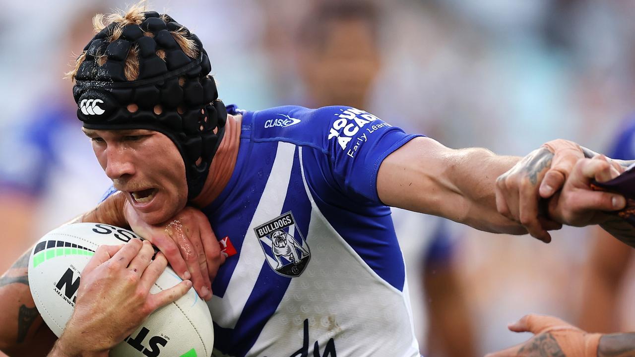 SYDNEY, AUSTRALIA - MARCH 20: Matt Burton of the Bulldogs is tackled during the round two NRL match between the Canterbury Bulldogs and the Brisbane Broncos at Accor Stadium, on March 20, 2022, in Sydney, Australia. (Photo by Mark Kolbe/Getty Images)