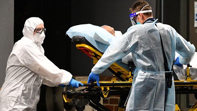 Healthcare workers transport a person into a patient transport vehicle at the Arcare Aged Care facility in Melbourne, Wednesday, June 2, 2021. (AAP Image/James Ross) NO ARCHIVING