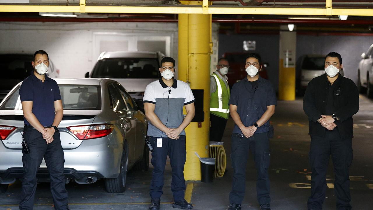 Serco staff members stand guard the car park entrance to the Park Hotel. Picture: Darrian Traynor/Getty Images