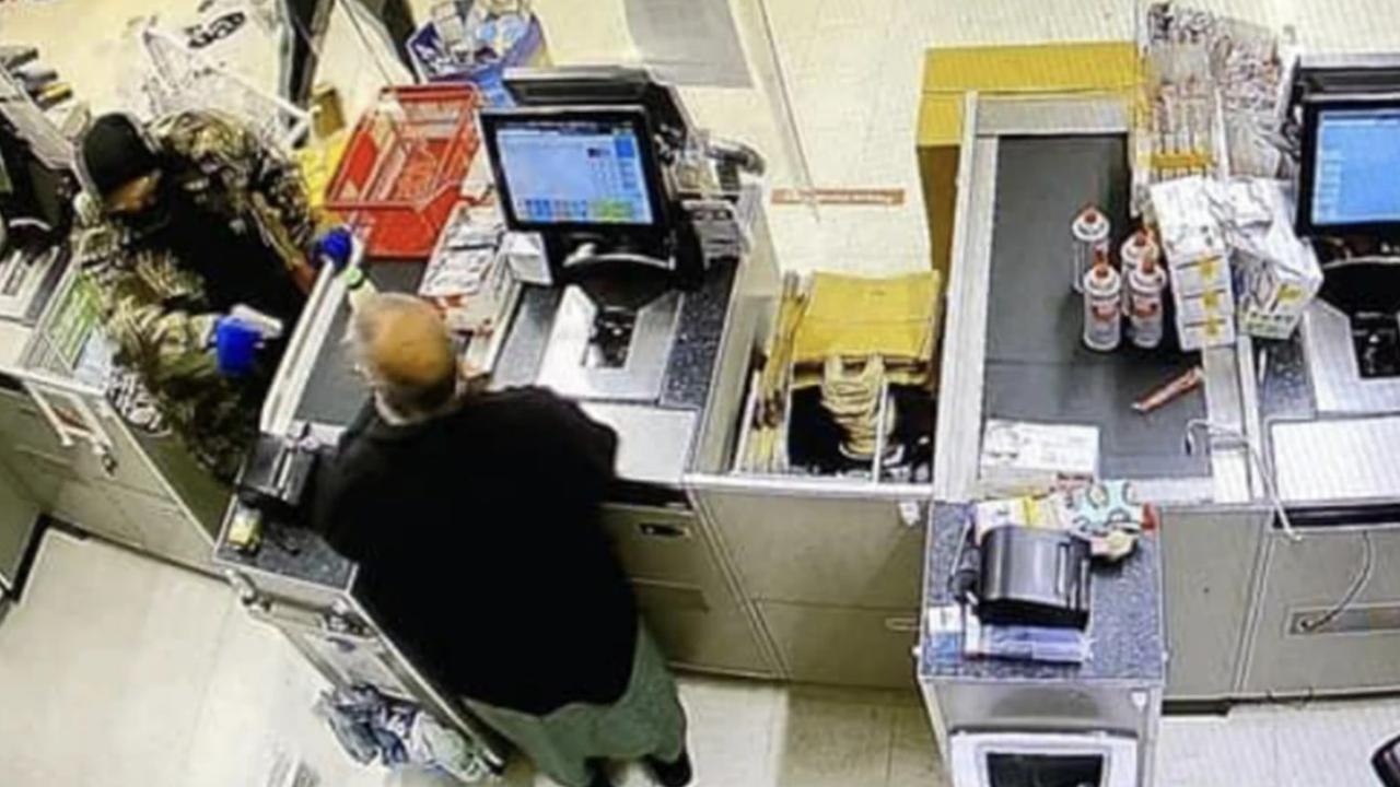 Kingston Gough points the gun at Ashfaq Farooqi shortly before he runs off to try and get help during the Boxing Day robbery. Picture: NZ Herald