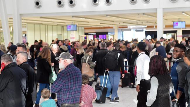 People lined up to go through security at Adelaide Airport as terror fears lead to beefed up security. Picture: Tom Huntley