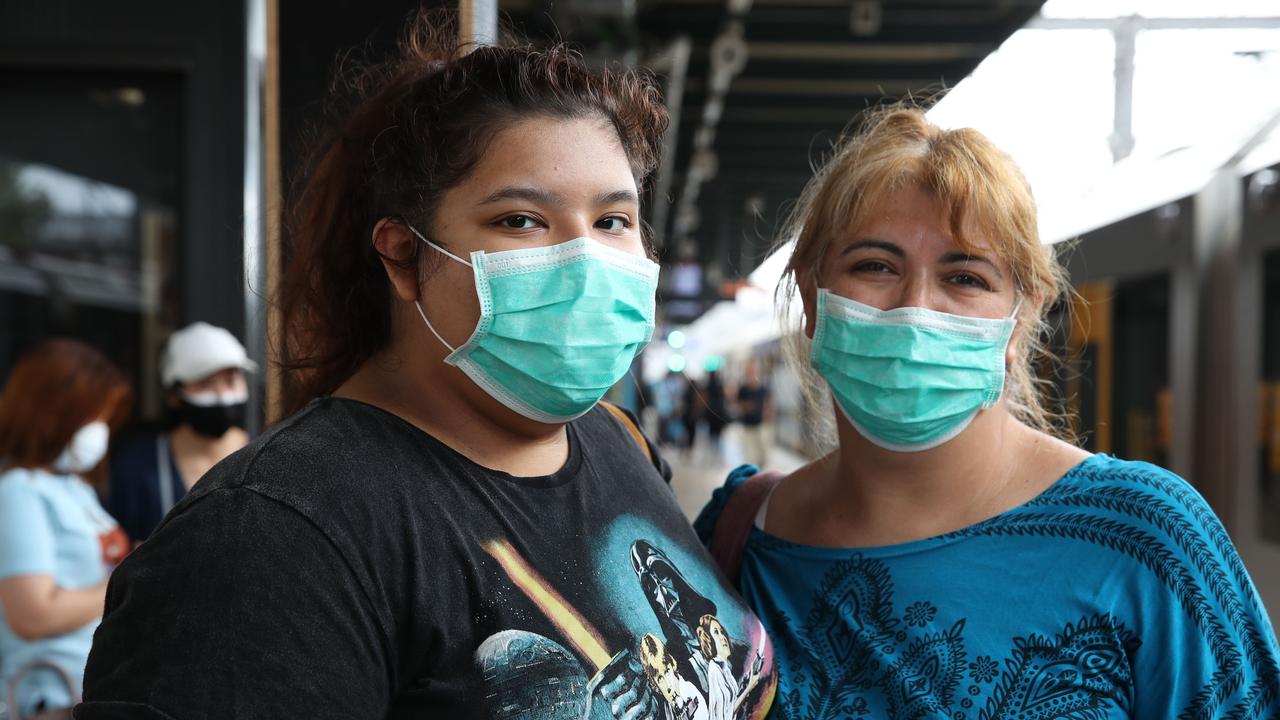 Ivy Sanchez and her mother Loreto wear face masks on a Sydney train line as concern over the coronavirus coming out of China grows. Picture: David Swift