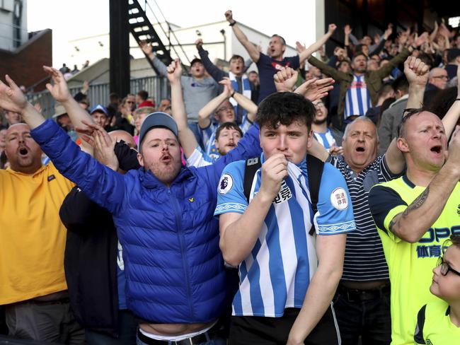 Huddersfield Town fans applaud their team after their relegation was confirmed after the English Premier League soccer match between Crystal Palace and Huddersfield Town at the Selhurst Park stadium, London. Saturday, March. 30, 2019 (Isabel Infantes/PA via AP)