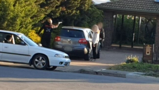 Matthew Kokotis points an imitation firearm at a person after threatening him with a baseball bat.