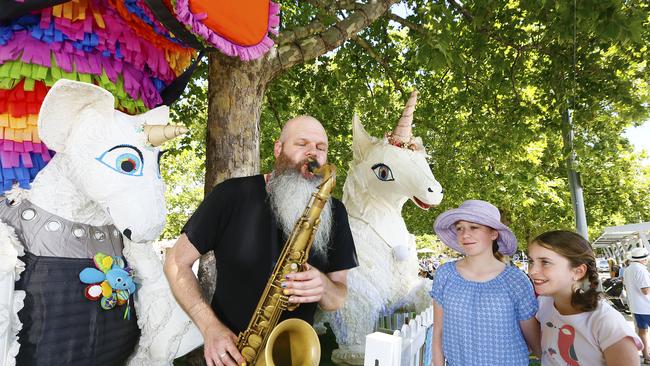 Adelaide children's entertainer, Adam Page, warms up as Sarah O’Reilly, 14, and Laura O’Reilly, 11, of Montrose look on. Picture: MATT THOMPSON
