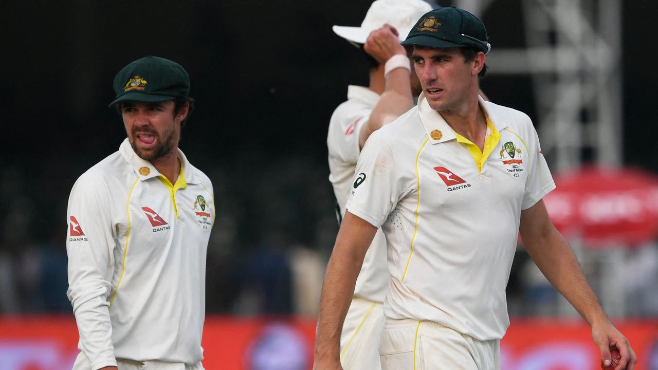 Australia's captain Pat Cummins (R) walks with teammates to the pavilion during the third day of the third cricket Test match between Pakistan and Australia at the Gaddafi Cricket Stadium in Lahore on March 23, 2022. (Photo by Aamir QURESHI / AFP)