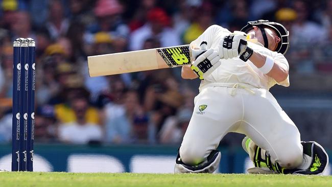 Steve Smith bends to avoid a short-pitched ball off England's Chris Woakes at the Gabba.