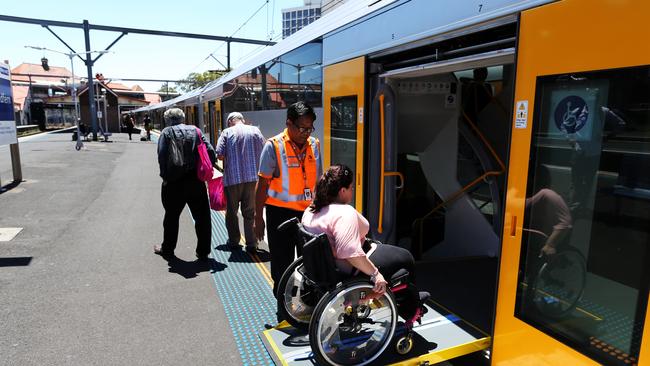 Wheelchair train passenger Pauline David at entering a train at Redfern station.