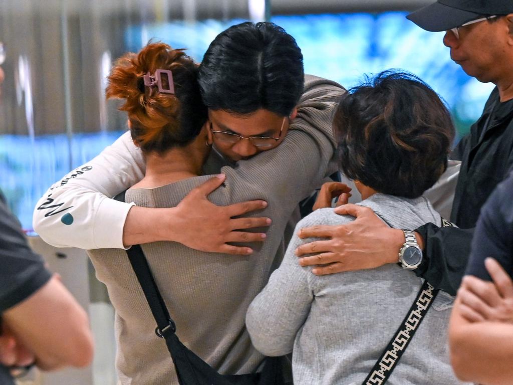 Passengers of Singapore Airlines flight SQ321 from London to Singapore are seen reuniting with loved ones after their ordeal in the air. Picture: Roslan Rahman/AFP