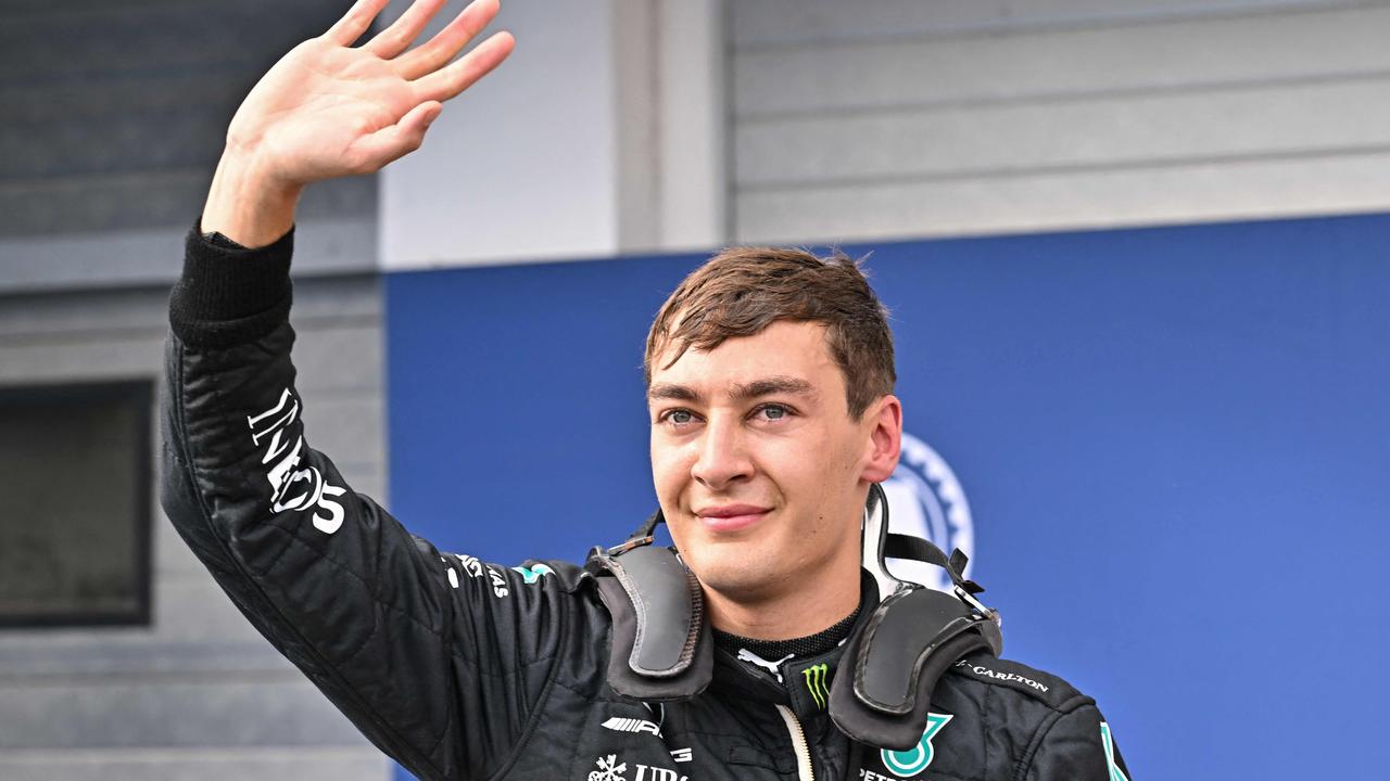 First placed Mercedes' British driver George Russell waves after winning the pole position during the qualifying session ahead of the Formula One Hungarian Grand Prix at the Hungaroring in Mogyorod near Budapest, Hungary, on July 30, 2022. (Photo by ATTILA KISBENEDEK / AFP)