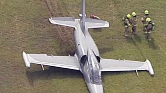 Firefighters inspect the jet which slid off the runway at Bankstown Airport. Picture: Channel 7