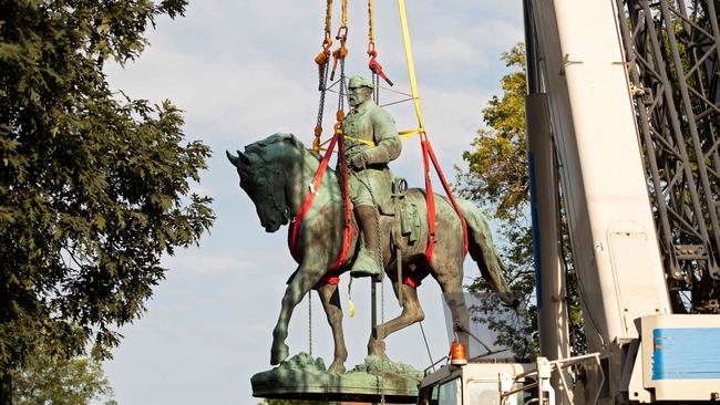 Workers remove the statue of Confederate General Robert E. Lee from a park in Charlottesville, Virginia. Picture: AFP,