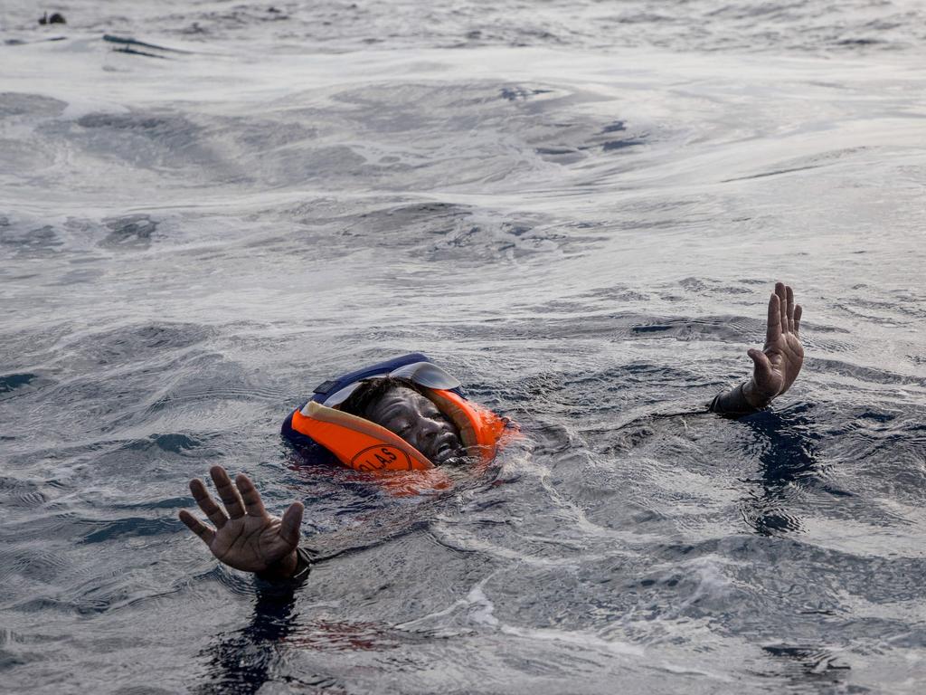 A weakened survivor of a migrant ship is found by a rescue boat in the Mediterranean Sea. Picture: AFP