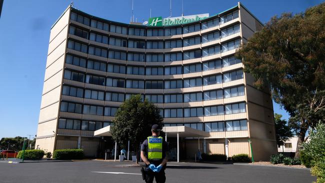 A police officer stands guard outside the Holiday Inn. Picture: Getty