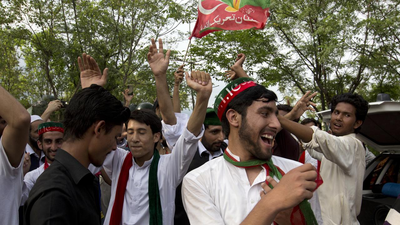 Supporters of Imran Khan celebrate his election victory outside his home in Islamabad.