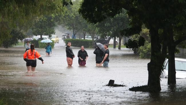 Residents in the flood waters of Bowen st, Windsor. Photo - Anthony Reginato