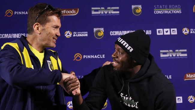 (L-R) coach Mike Mulvey welcomes Usain Bolt to the Central Coast Mariners. Picture: Brett Costello