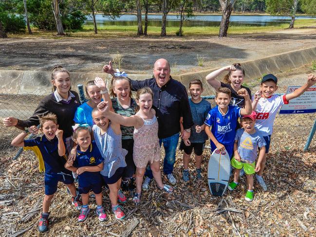 Stephen Ross (centre) and local children have called on the State Government since last February to open Hope Valley Reservoir as a tourist destination. Picture: AAP/Roy Vandervegt.