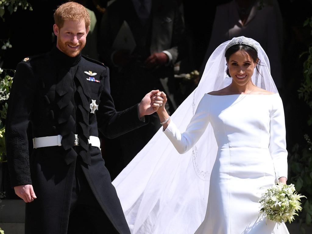 Britain's Prince Harry (L), Duke of Sussex and Meghan (R), Duchess of Sussex exit St George's Chapel in Windsor Castle. Picture: Reuters