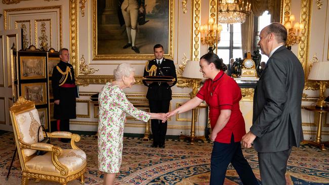 The Queen presents the George Cross to Peter May and Sister Joanna Hogg. Picture: AFP