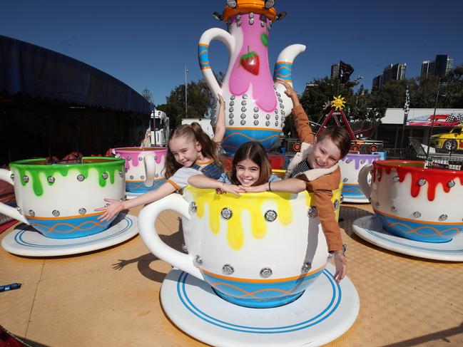 The Gold Coast Show starts Thursday and locals Pippa Tucker 8, Ayla Shephard 8, and Van Taurima 8, get an early ride in on the Teacups. Picture: Glenn Hampson