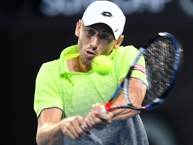 Australian John Millman returns during his first round match against Peter Polansky of Canada at the Brisbane International Tennis Tournament in Brisbane, Tuesday, January 2, 2018. (AAP Image/Dave Hunt) NO ARCHIVING, EDITORIAL USE ONLY