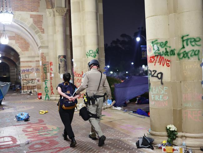 A protester is detained as authorities clear a pro-Palestinian encampment at UCLA. The university declared the camp “unlawful,” and over 100 protesters who remained were detained. Similar encampments have emerged nationwide, urging schools to divest from Israeli interests amid the Gaza conflict. Picture: Mario Tama/Getty Images