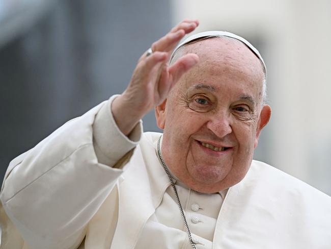 (FILES) Pope Francis waves to the crowd during the weekly general audience at St Peter's Square in The Vatican on November 20, 2024. Pope Francis has "stable" conditions with his blood tests showing a "slight improvement", the Vatican said on February 19, 2025, as the 88-year-old pontiff undergoes ongoing treatment for bronchitis in both lungs. (Photo by Filippo MONTEFORTE / AFP)