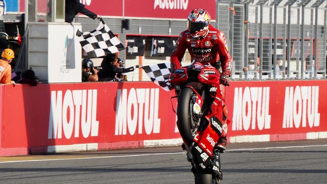 Jack Miller greets the chequered flag in style. (Photo by Toshifumi KITAMURA / AFP)