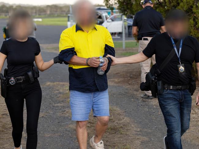 A man is arrested by police. Picture: AFP