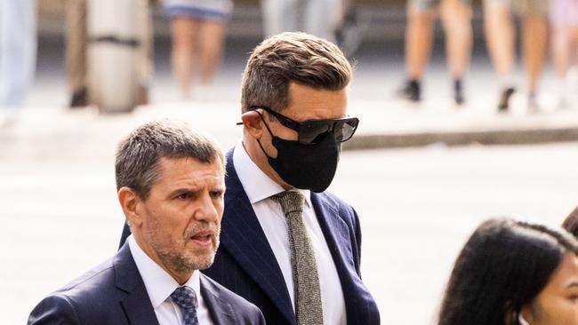 Howard (pictured wearing mask) was defended in court by his lawyer John Sutton. Picture: NCA NewsWire/ Ben Symons