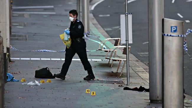 Forensic police at the CBD crime scene on Friday morning. Picture: Adam Yip