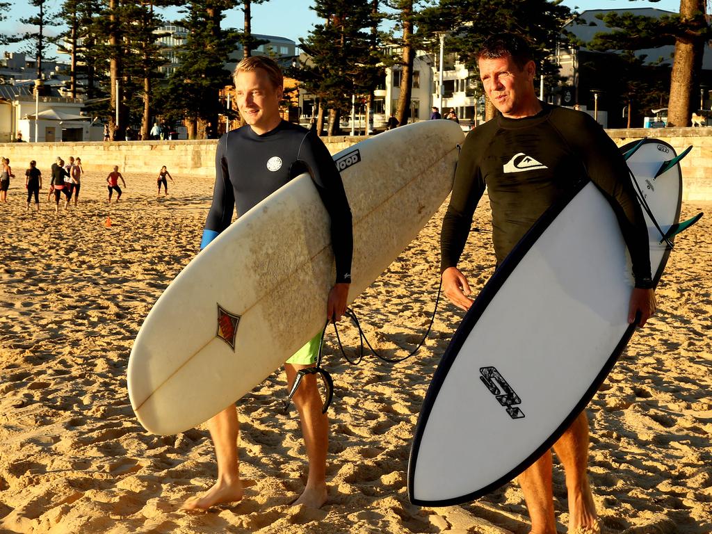 Manly MP James Griffin and Mike Baird going for a surf at Manly.