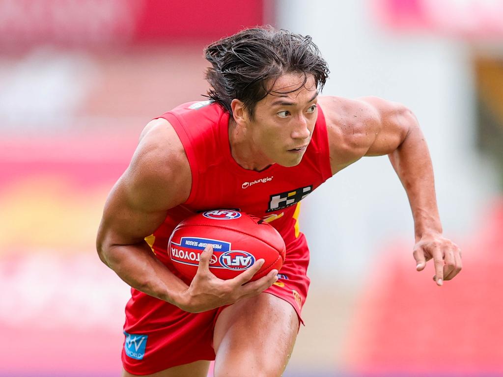 Alex Davies of the Suns carries the ball during an AFL practice match between the Gold Coast Suns and Port Adelaide Power at Metricon Stadium. Picture: Russell Freeman/Getty Images.