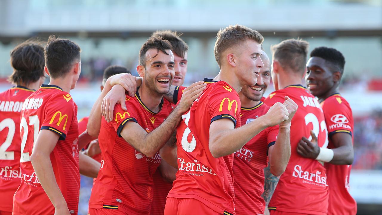 Adelaide celebrate Riley McGree’s brilliant second goal against Newcastle. (Photo by Tony Feder/Getty Images)