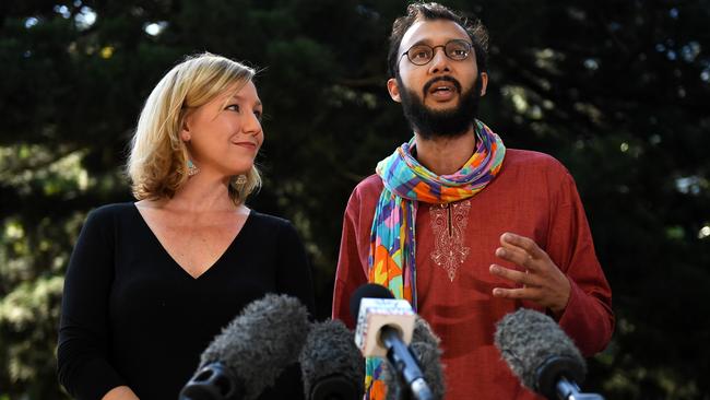 Greens Senator Larissa Waters (left) listens to Brisbane City Councillor Jonathan Sri speaking to the media after she announced her resignation in Brisbane, Tuesday, July 18, 2017. Ms Waters resigned as a result of her dual Australian-Canadian citizenship. Picture: AAP /Dan Peled.